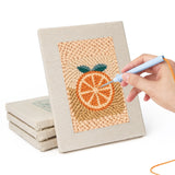 Hand punching one of the Citrus and Blackberries mini canvases