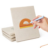 Hand punching one of the Classroom Globe mini canvases