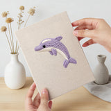 Hand holding a finished Clownfish Reef mini canvas
