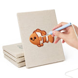 Hand punching one of the Clownfish Reef mini canvases
