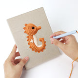 Punching a Clownfish Reef mini canvas with the punch needle