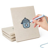 Hand punching one of the Coconut Crepe Cafe mini canvases