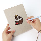 Punching a Coconut Crepe Cafe mini canvas with the punch needle
