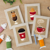 The four finished Coffee Shop Cups mini canvases laid out on a table