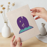 Hand holding a finished Coffin and Gravestone mini canvas