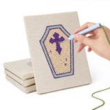 Hand punching one of the Coffin and Gravestone mini canvases