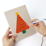 Punching a Colorful Christmas Trees mini canvas with the punch needle