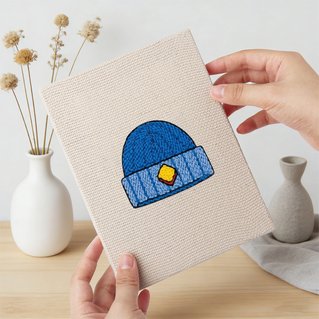 Hand holding a finished Colorful Hats mini canvas