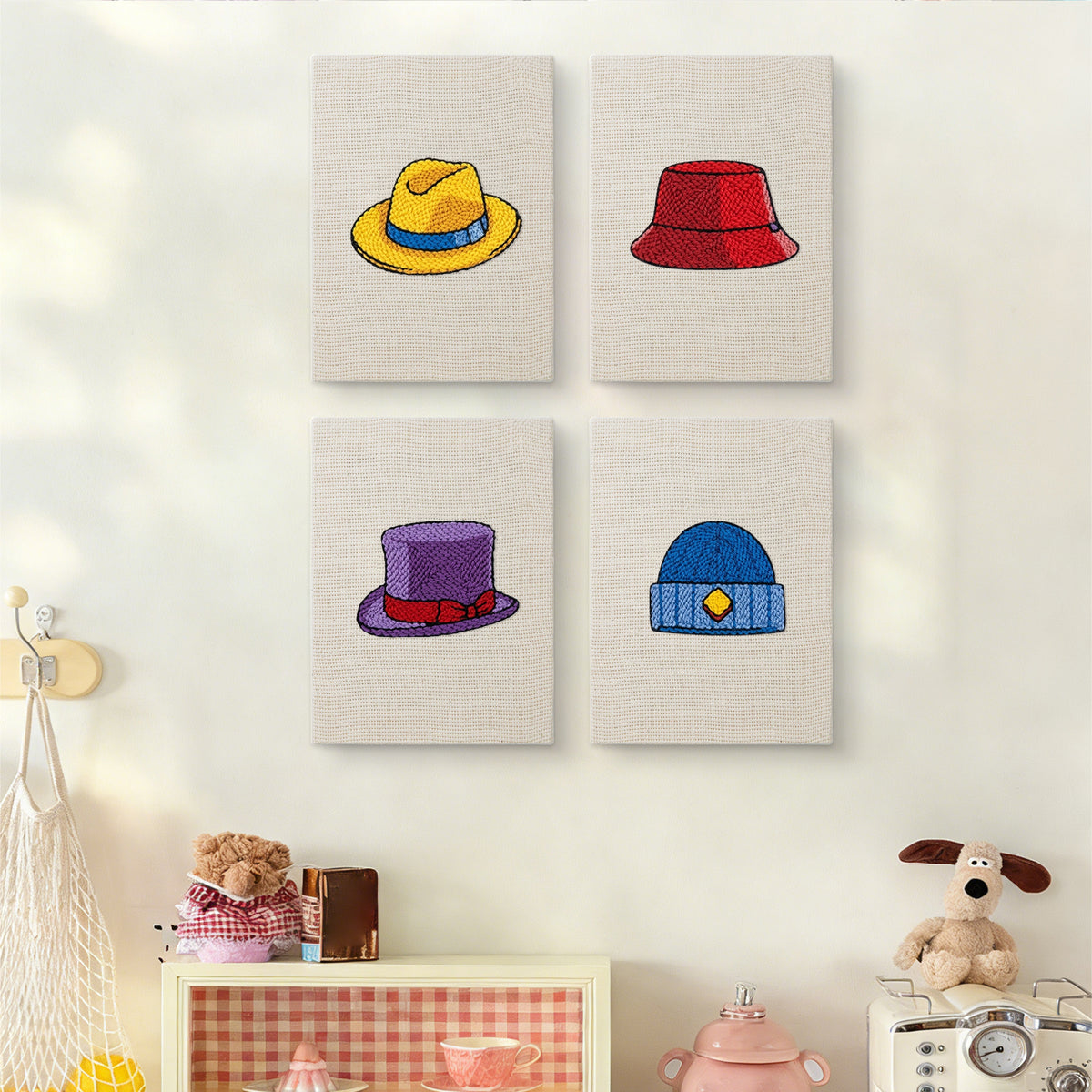 The four Colorful Hats mini canvases on a wall above a shelf