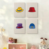 The four Colorful Hats mini canvases on a wall above a shelf