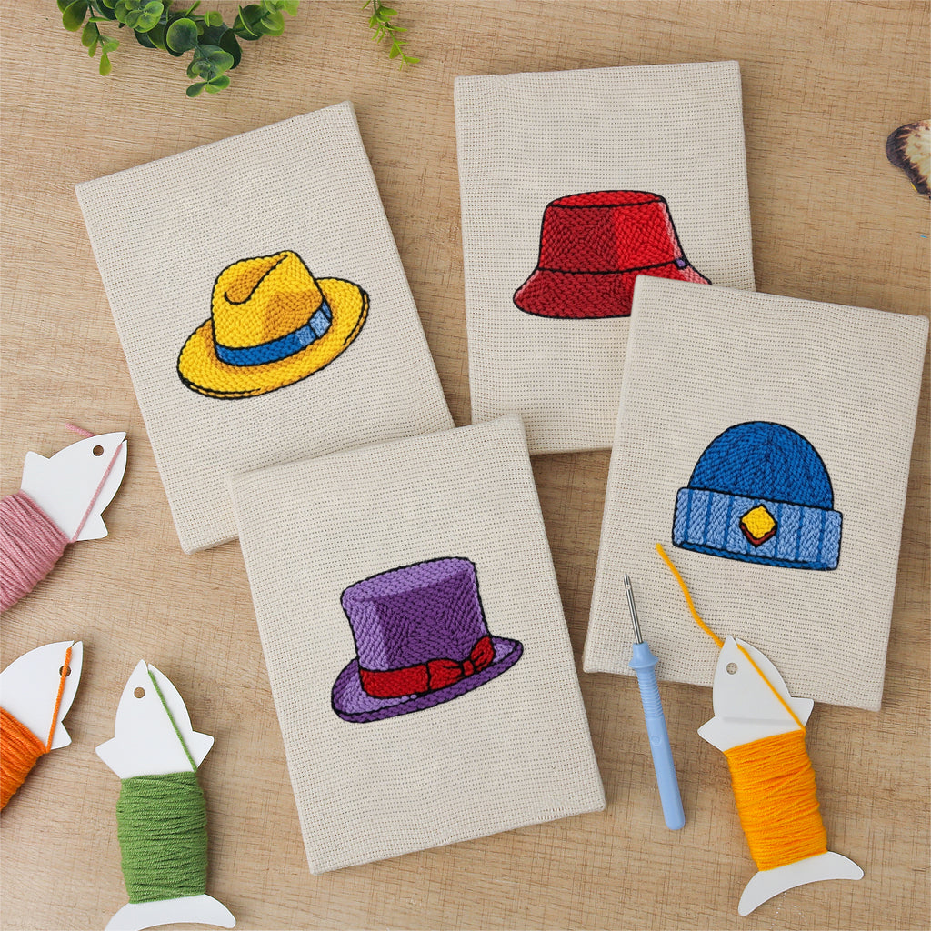 The four finished Colorful Hats mini canvases laid out on a table
