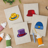 The four finished Colorful Hats mini canvases laid out on a table