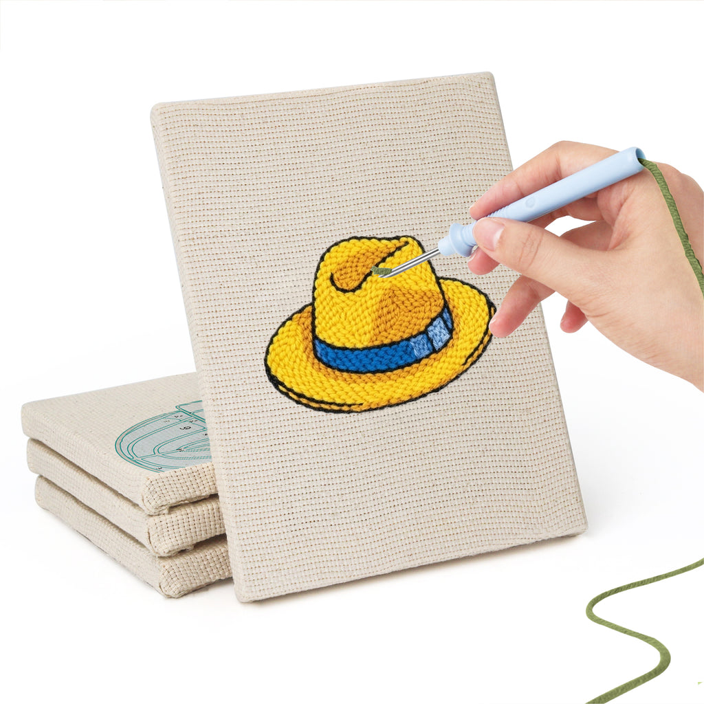 Hand punching one of the Colorful Hats mini canvases