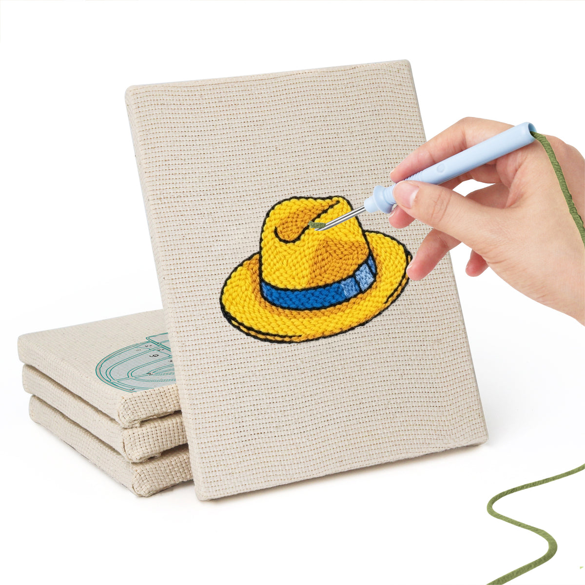 Hand punching one of the Colorful Hats mini canvases