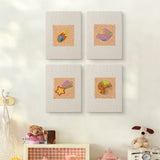 The four Comet and Planets mini canvases on a wall above a shelf