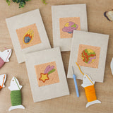 The four finished Comet and Planets mini canvases laid out on a table
