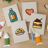 The four finished Cookie and Cake mini canvases laid out on a table