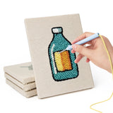Hand punching one of the Cookie and Cake mini canvases