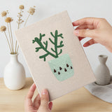 Hand holding a finished Cool Tone Planters mini canvas