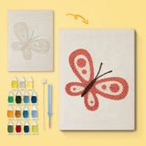 Coral Butterfly canvas before and after punching, with the threads and tools
