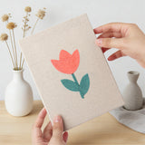 Hand holding a finished Coral Spring Blooms mini canvas