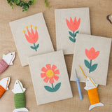 The four finished Coral Spring Blooms mini canvases laid out on a table