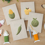 The four finished Corn and Cabbage mini canvases laid out on a table