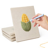 Hand punching one of the Corn and Cabbage mini canvases