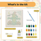 What is in the Corn Cob Scarecrow kit: printed canvas, punch needle, threader, threads, color guide and hangers