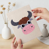 Hand holding a finished Cow and Buffalo mini canvas