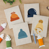 The four finished Cozy Beanies mini canvases laid out on a table