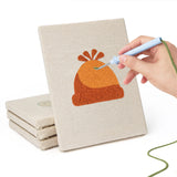 Hand punching one of the Cozy Beanies mini canvases