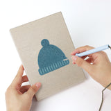 Punching a Cozy Beanies mini canvas with the punch needle