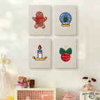 The four Cozy Christmas mini canvases on a wall above a shelf