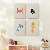 The four Crab and Angelfish mini canvases on a wall above a shelf