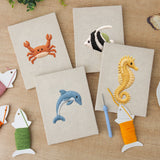 The four finished Crab and Angelfish mini canvases laid out on a table