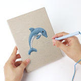 Punching a Crab and Angelfish mini canvas with the punch needle