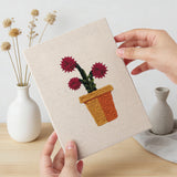 Hand holding a finished Crimson Bloom Pots mini canvas