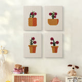 The four Crimson Bloom Pots mini canvases on a wall above a shelf