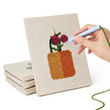 Hand punching one of the Crimson Bloom Pots mini canvases