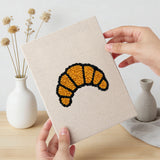 Hand holding a finished Croissant Tea Break mini canvas