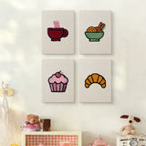 The four Croissant Tea Break mini canvases on a wall above a shelf