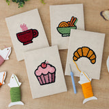The four finished Croissant Tea Break mini canvases laid out on a table