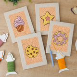 The four finished Cupcake and Donut mini canvases laid out on a table