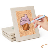 Hand punching one of the Cupcake and Donut mini canvases