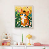 Finished Daisy Meadow Kitten punch needle canvas on a wall