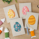The four finished Daisy Star Eggs mini canvases laid out on a table