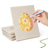 Hand punching one of the Daisy Star Eggs mini canvases