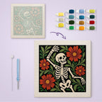 Dancing Skeleton canvas before and after punching, with the threads and tools