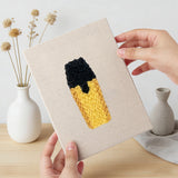 Hand holding a finished Desk Essentials mini canvas